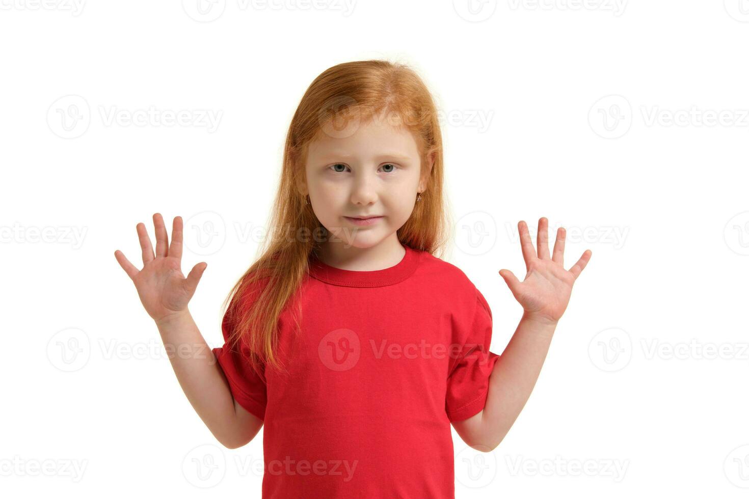 Little girl smiling with his arms up. 5 years old girl surprised with smile and hands near her hands photo