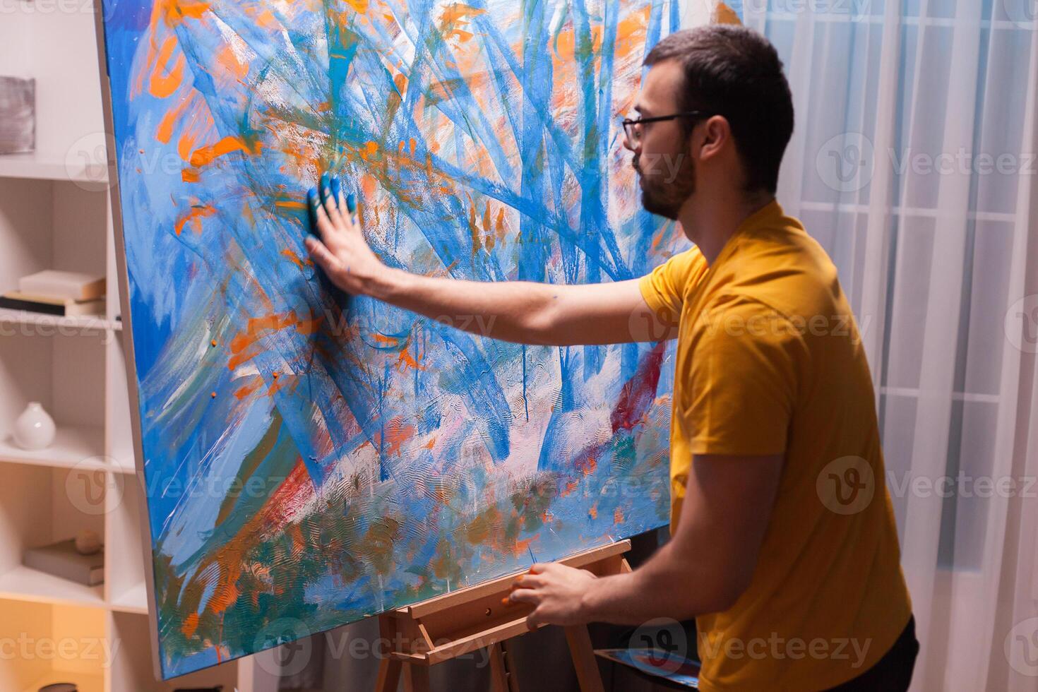 Inspired painter in art workshop painting with hands on canvas. Modern artwork paint on canvas, creative, contemporary and successful fine art artist drawing masterpiece photo