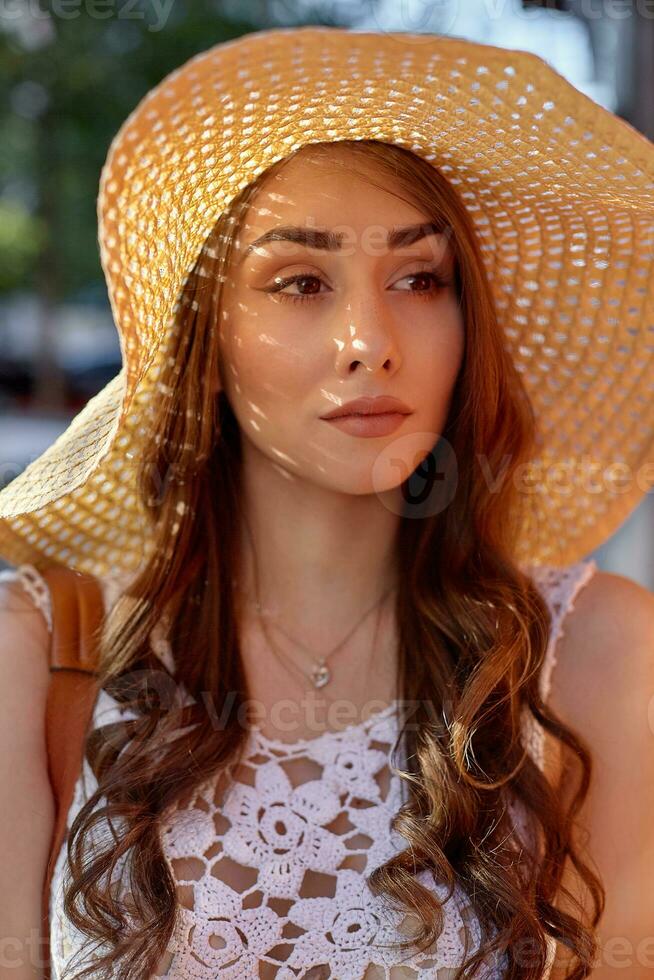 Fashion portrait of young stylish hipster woman walking on the street, wearing trendy outfit, straw hat, travel. photo