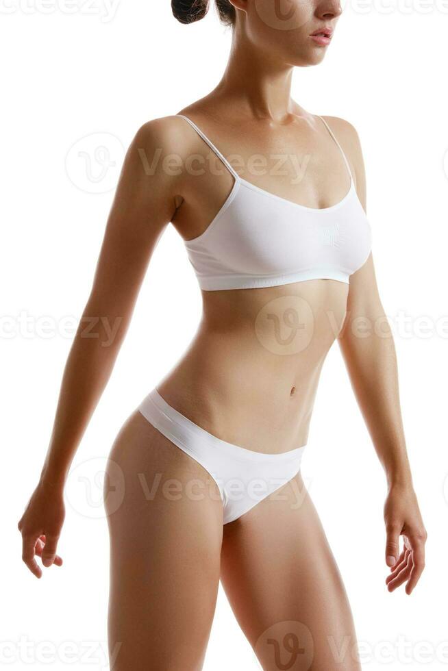 Perfect, slim, toned, young body of a girl in white underwear posing  isolated on white. Plastic surgery and aesthetic cosmetology concept.  Close-up. 35179207 Stock Photo at Vecteezy