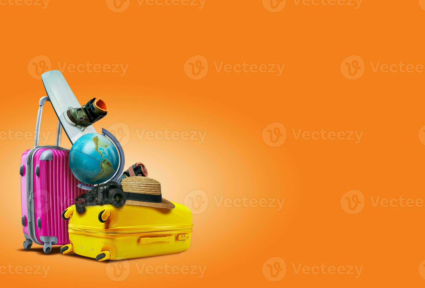 Purple and yellow suitcases against an orange background. There are a globe, wakeboard, hat and camera laying on them. Collage. Copy space, close-up. photo