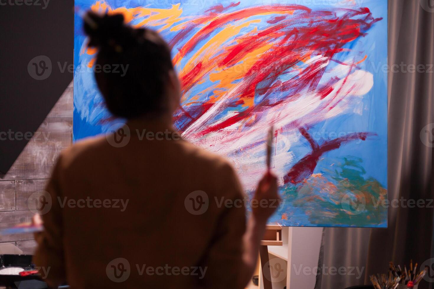 Painter in art workshop looking at painting composition in art studio. Modern artwork paint on canvas, creative, contemporary and successful fine art artist drawing masterpiece photo