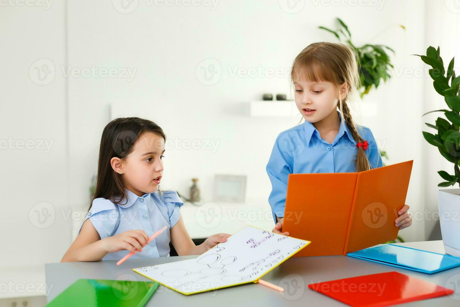 Pretty stylish schoolgirls studying during her online lesson at home, social distance during quarantine, self-isolation, online education concept photo