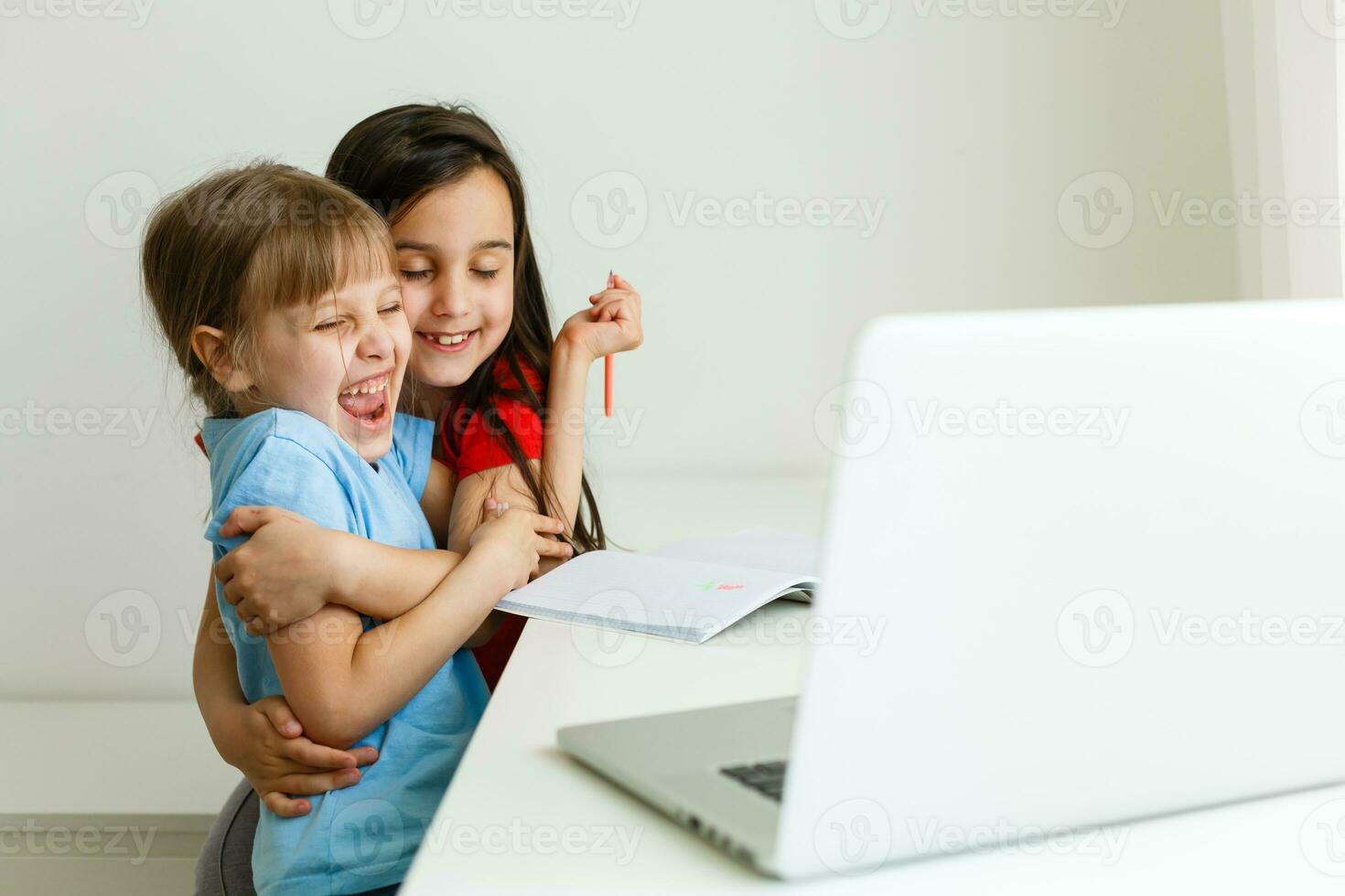 Pretty stylish schoolgirls studying math during her online lesson at home, social distance during quarantine, self-isolation, online education concept photo