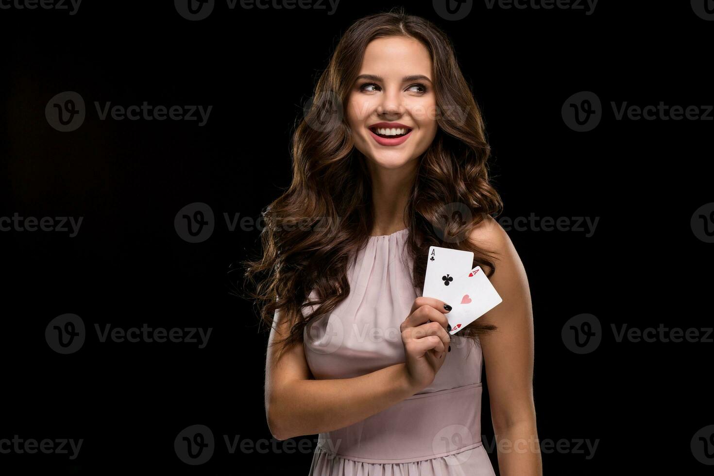 Attractive young woman holding the winning combination of poker cards photo
