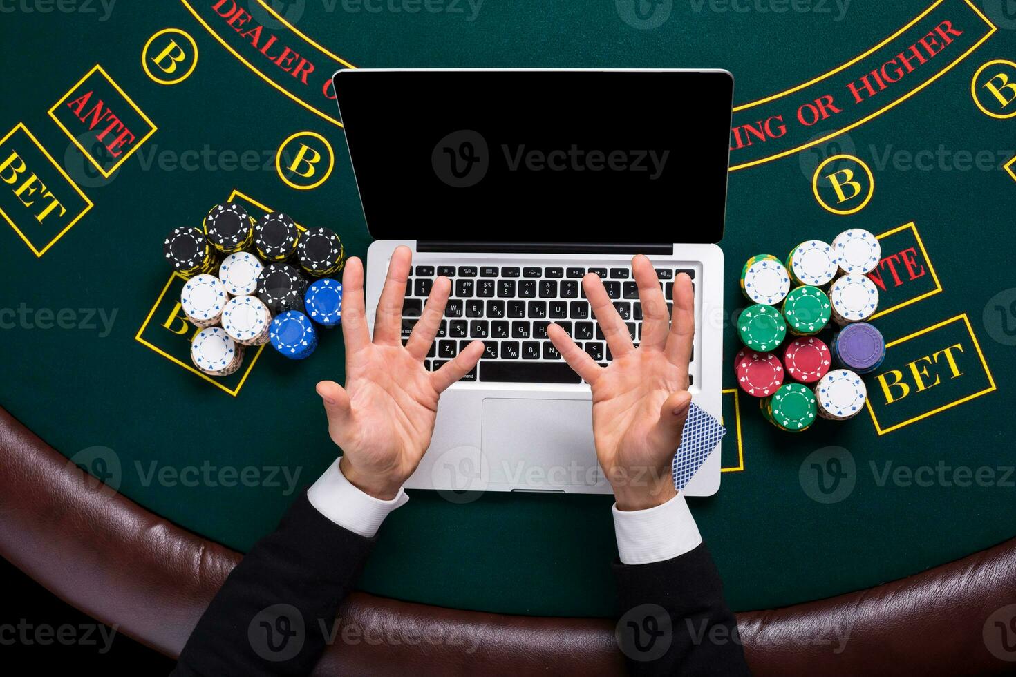 casino, online gambling, technology and people concept - close up of poker player with playing cards photo