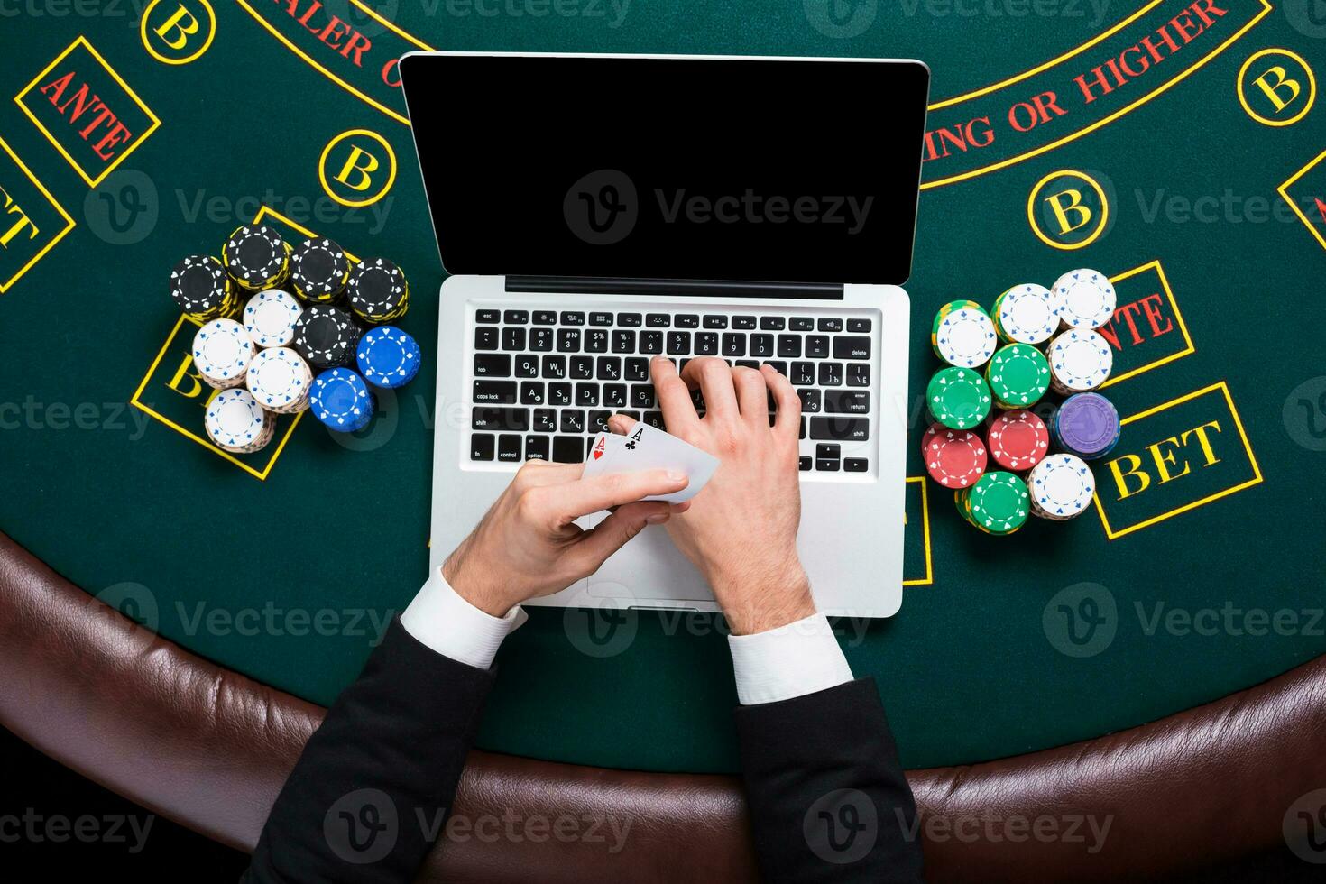 casino, online gambling, technology and people concept - close up of poker player with playing cards photo