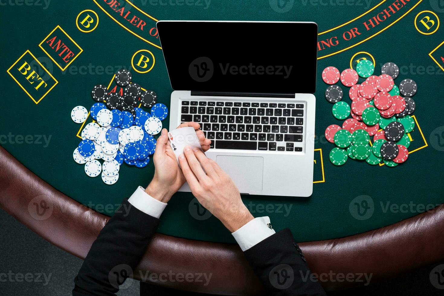 casino, online gambling, technology and people concept - close up of poker player with playing cards photo