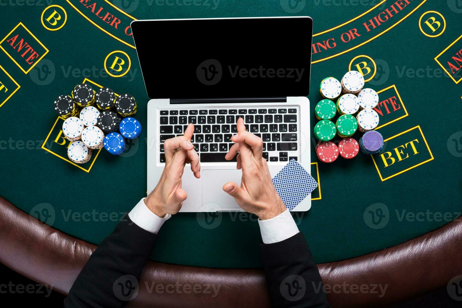 casino, online gambling, technology and people concept - close up of poker player with playing cards photo