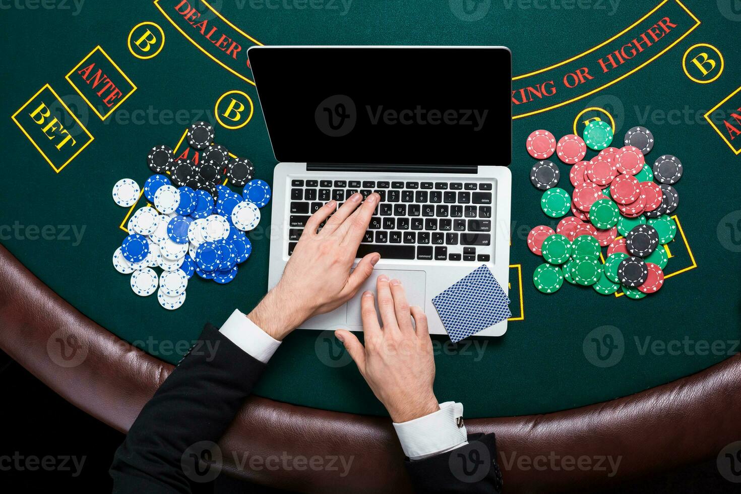 casino, online gambling, technology and people concept - close up of poker player with playing cards photo