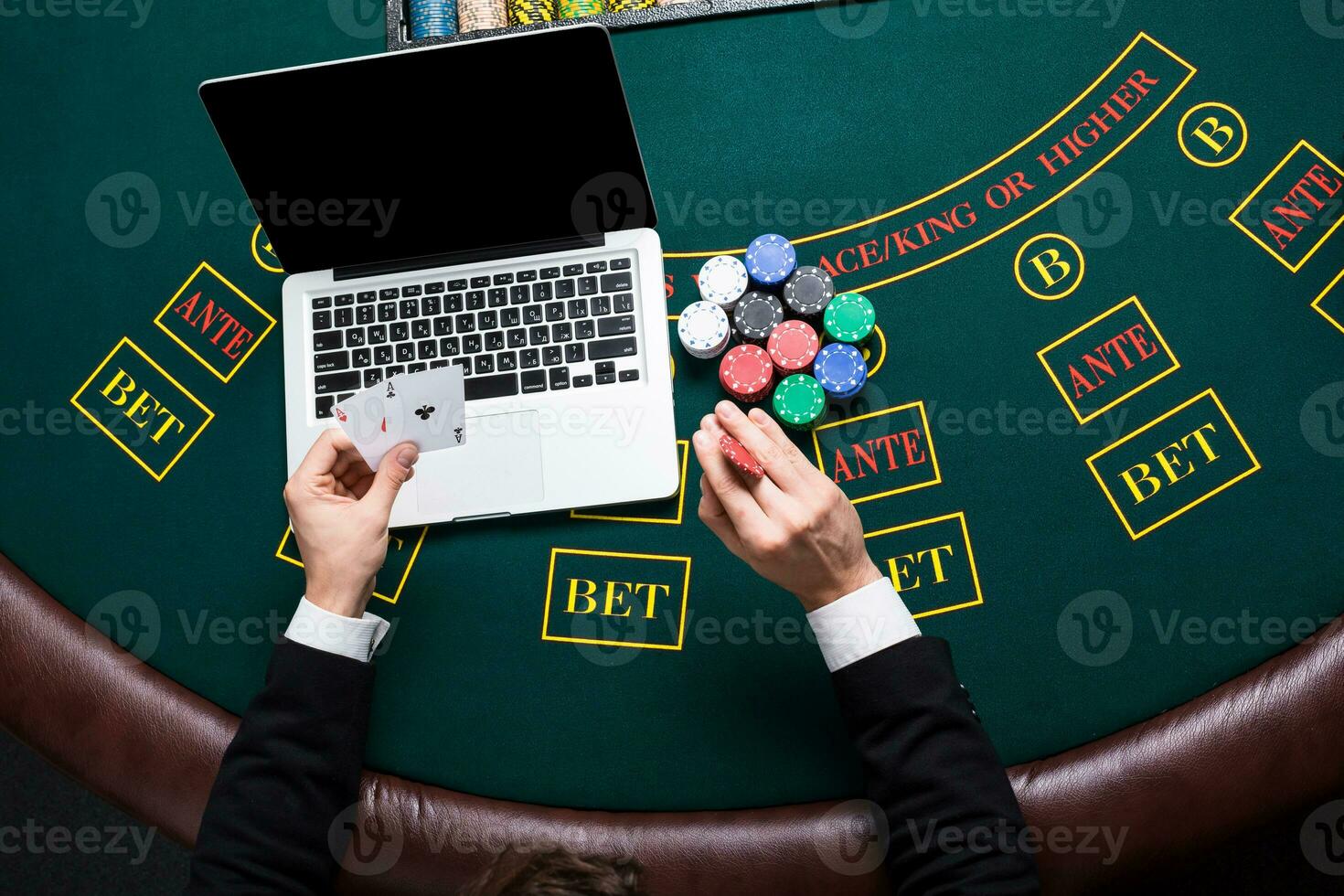 casino, online gambling, technology and people concept - close up of poker player with playing cards photo