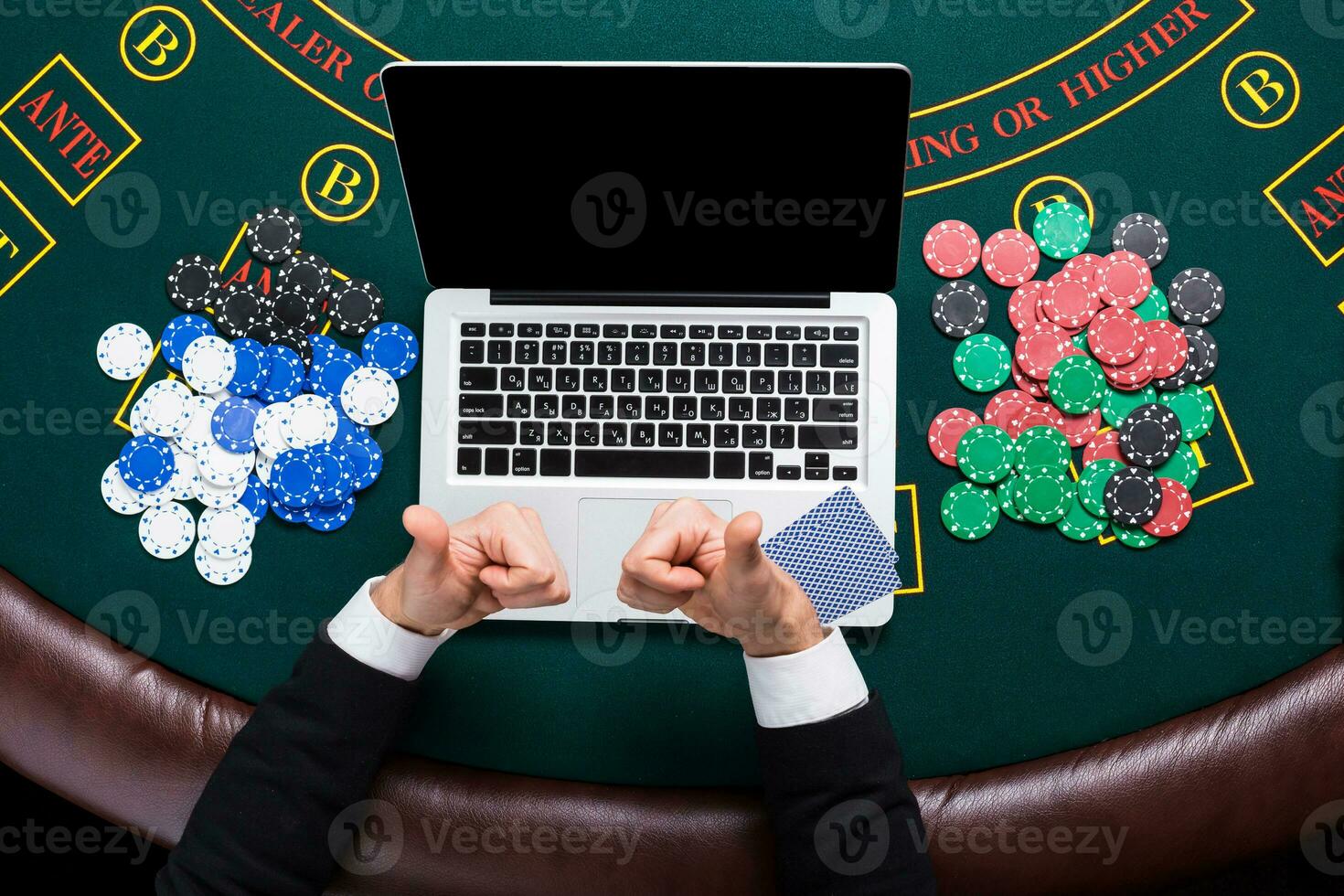 casino, online gambling, technology and people concept - close up of poker player with playing cards photo