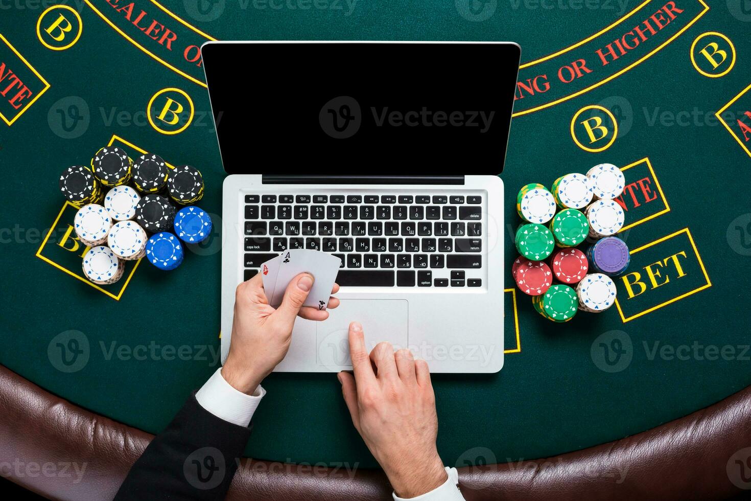 casino, online gambling, technology and people concept - close up of poker player with playing cards photo