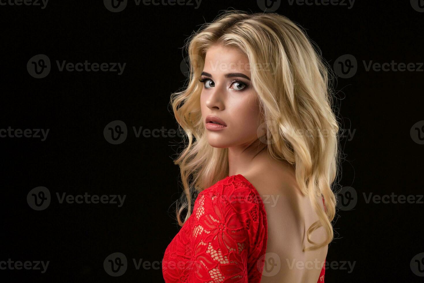 Beautiful sexy blonde woman on black background, party. photo