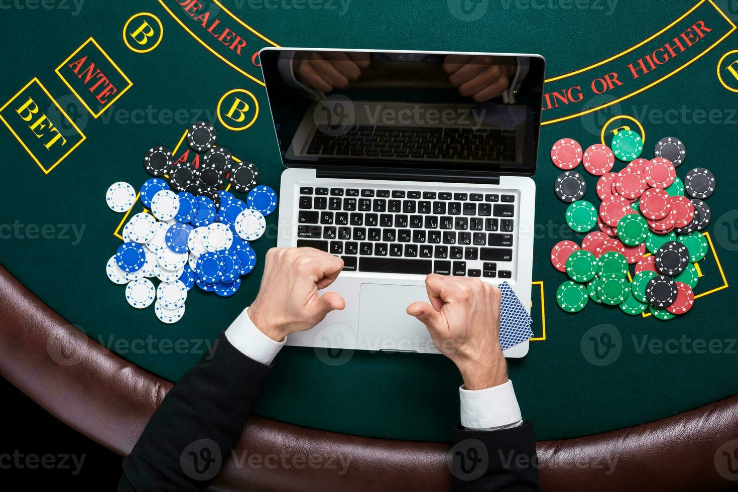 casino, online gambling, technology and people concept - close up of poker player with playing cards photo
