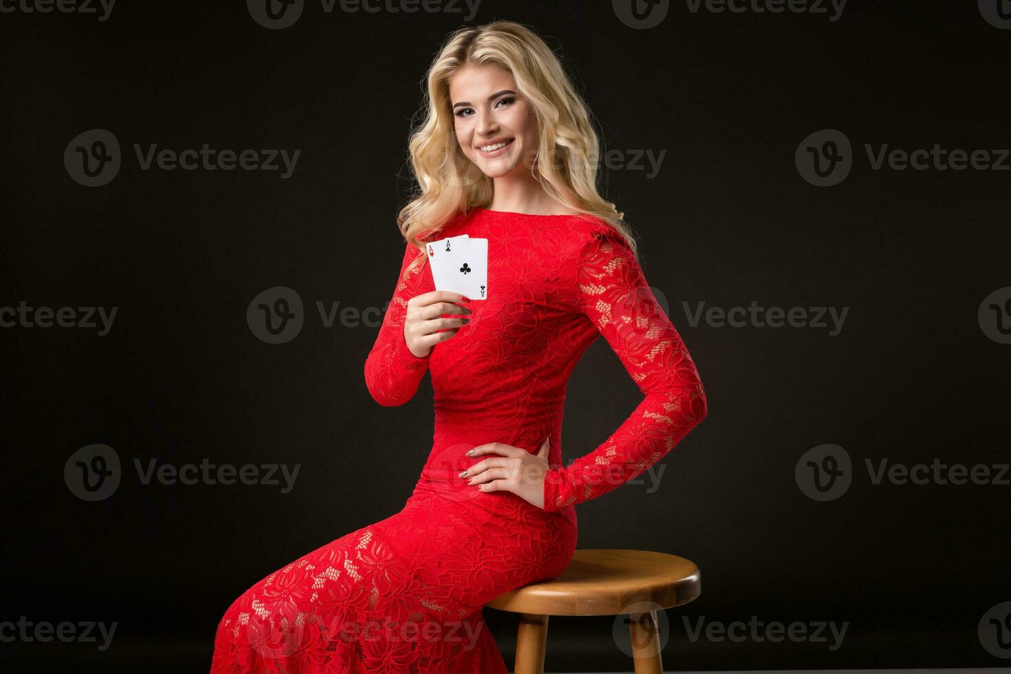 Young woman in casino with cards over black background. Poker photo