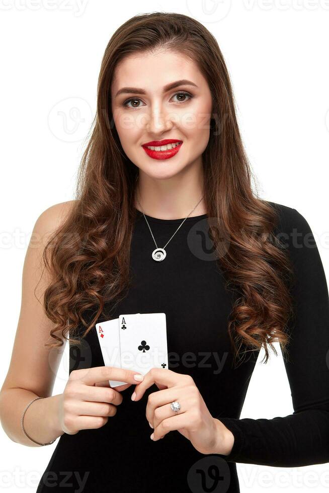 Sexy curly hair brunette posing with two aces cards in her hands, poker concept isolation on white background photo