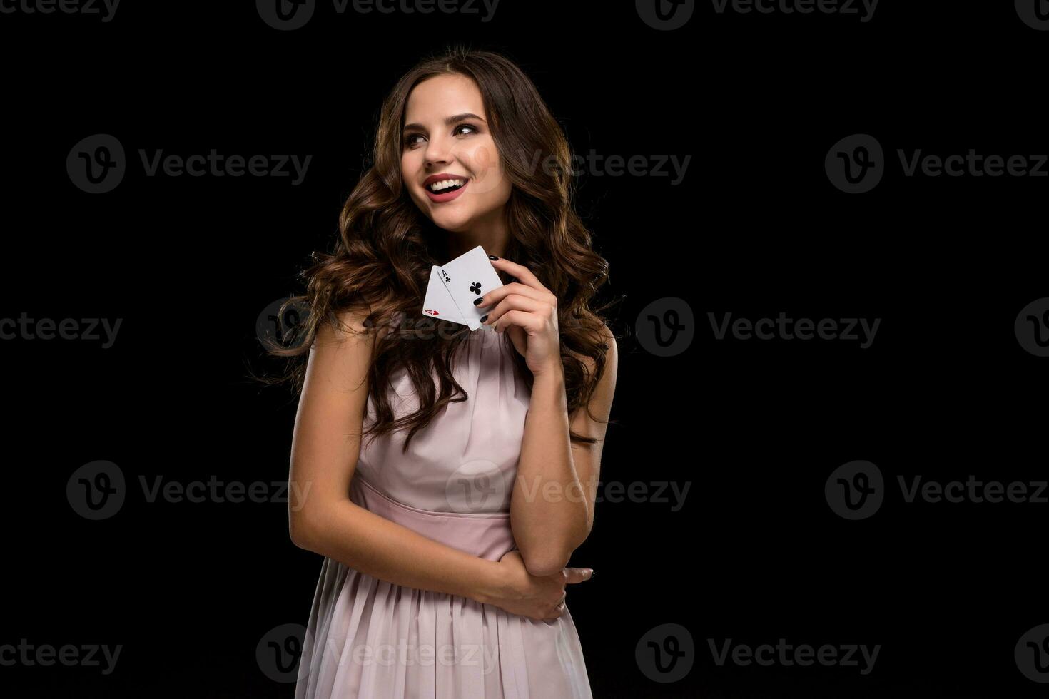 Sexy curly hair brunette posing with chips in her hands, poker concept black background photo