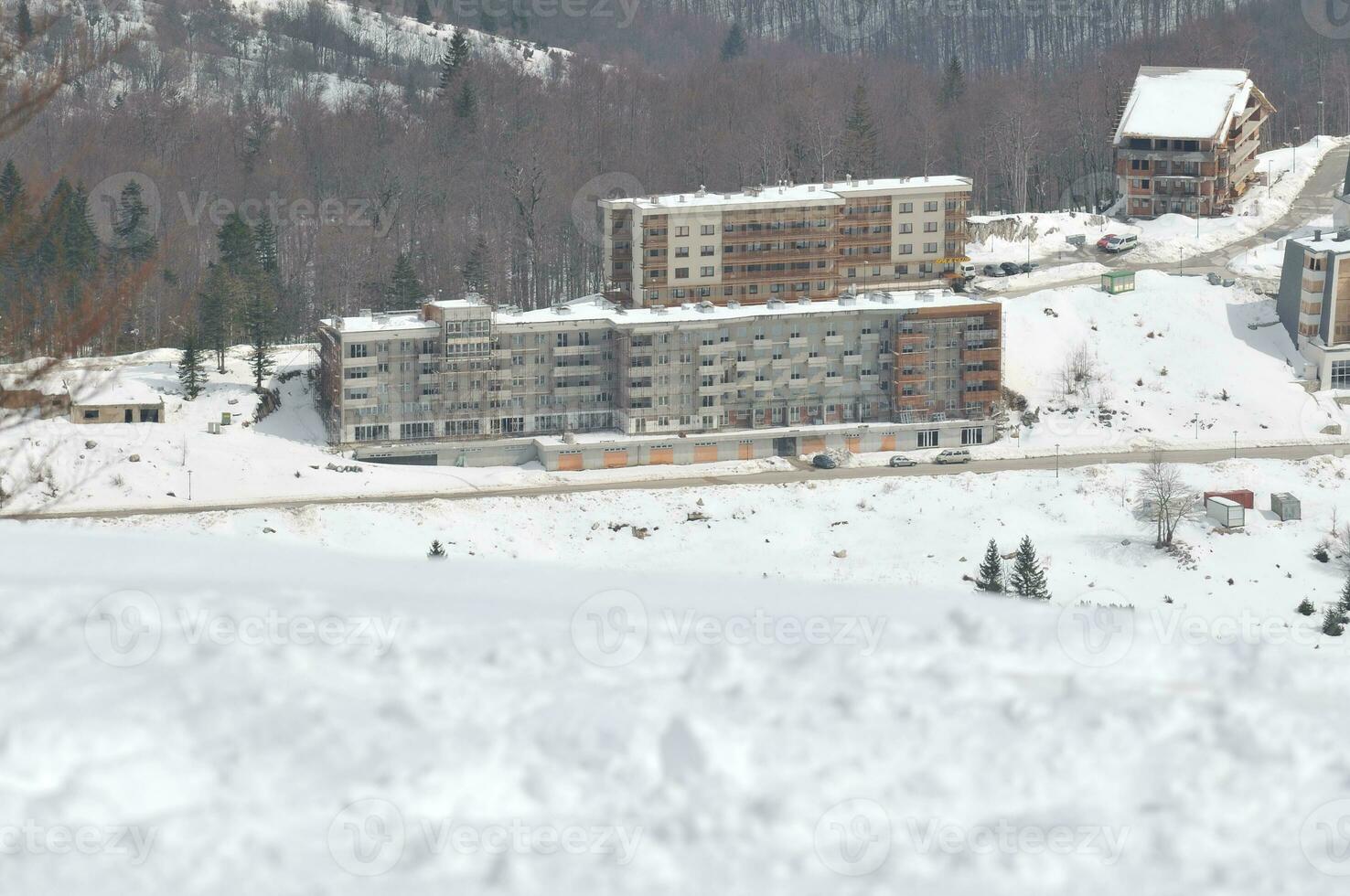 a snowy mountain with buildings on it photo