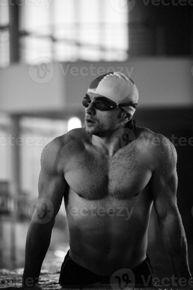 a man in a swimming pool wearing goggles photo