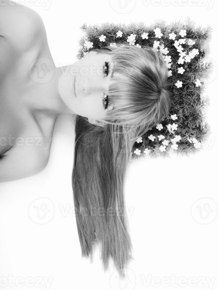 a black and white photo of a woman with flowers