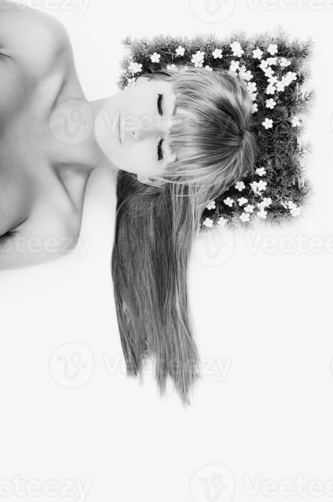 a black and white photo of a woman with flowers