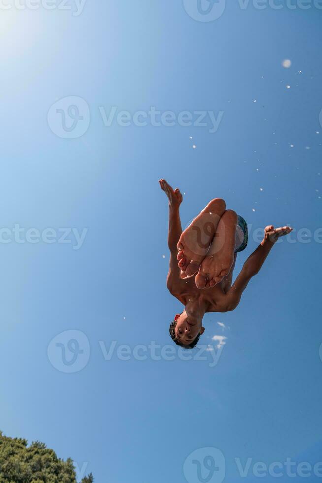 a man in a swimsuit is doing a flip in the air photo