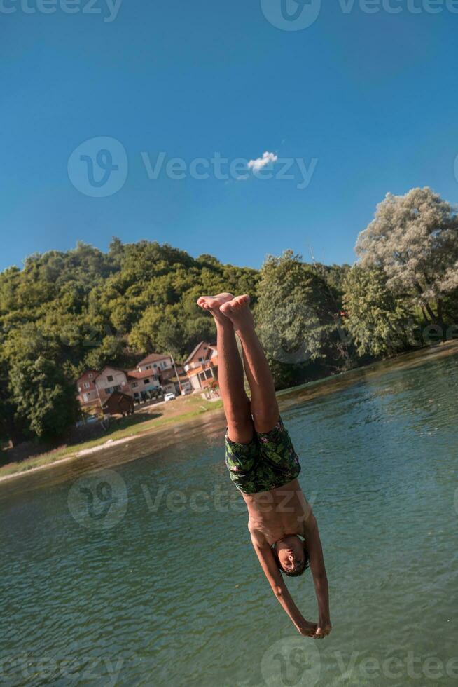 a man in a swimsuit is jumping into the water photo