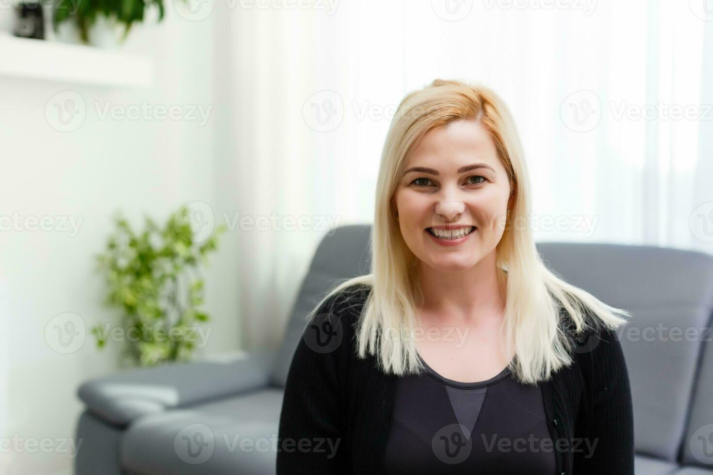 Headshot portrait of smiling young woman. girl with happy facial expression looking at camera with joy, communicating with friends via internet telephony, making video call. Close up. Front view photo