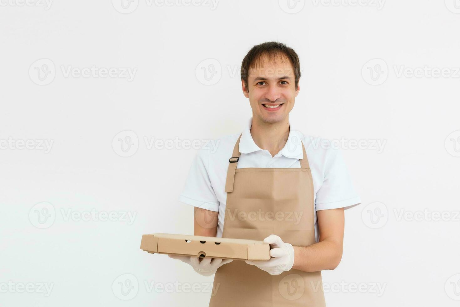 Photo of happy man from delivery service in t-shirt giving food order and holding pizza boxes isolated over white background