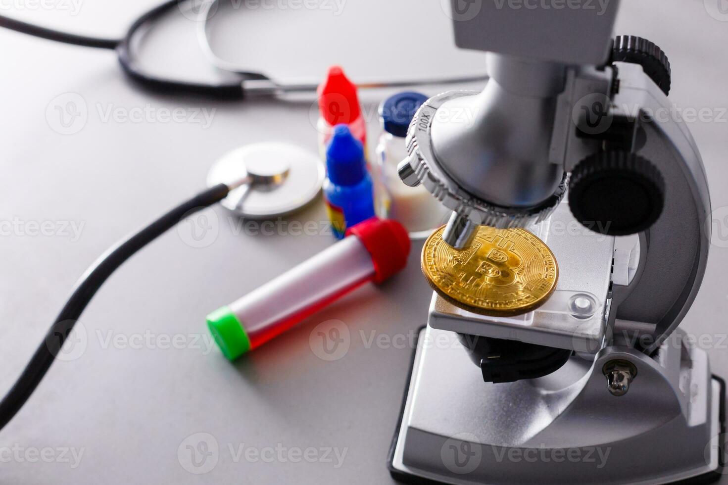 Coin crypto currency bitcoin lies on the microscope background theme of the gold exchange pyramid for money due to the rise or fall of the exchange rate. photo