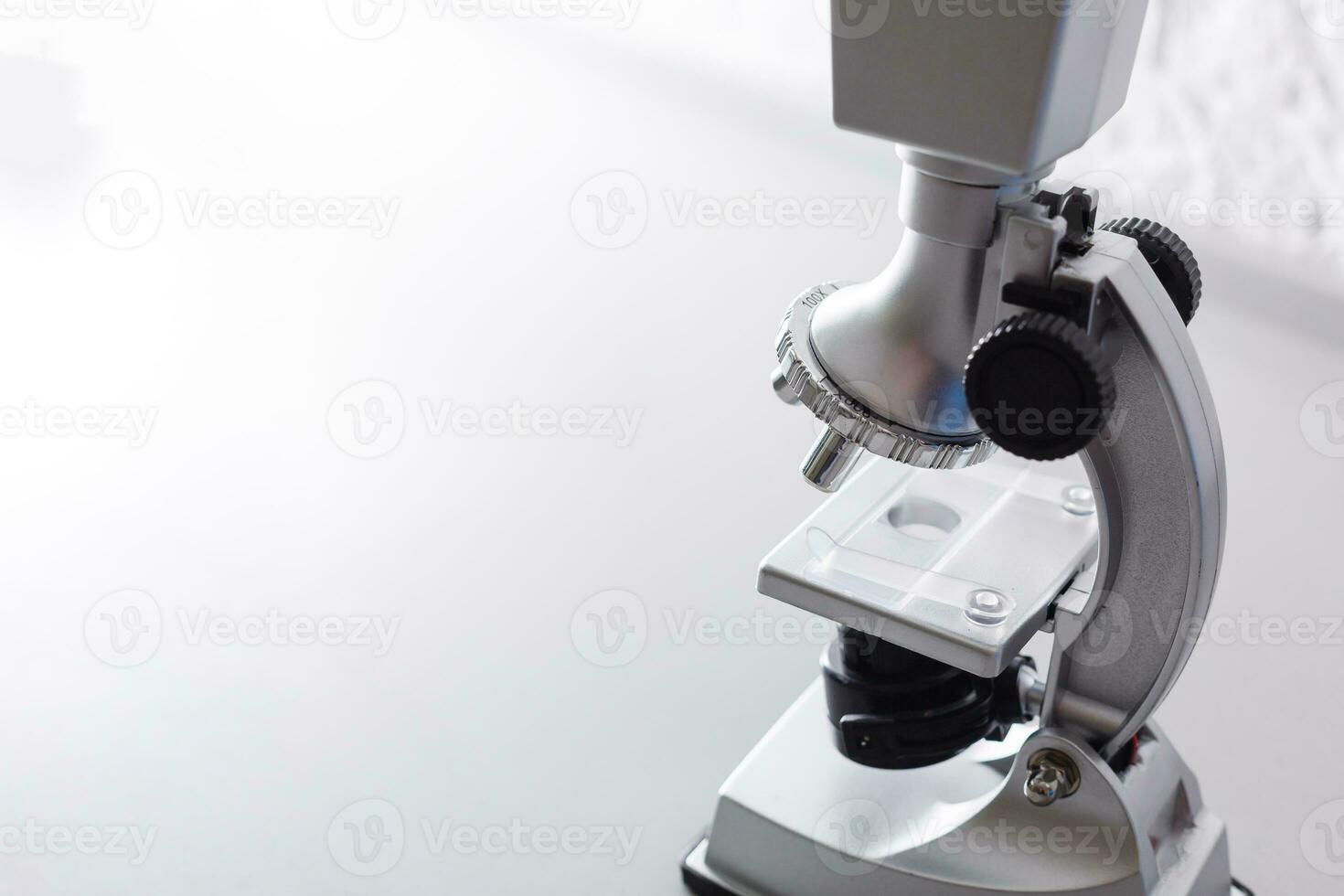 microscope stands on a table on a white background photo