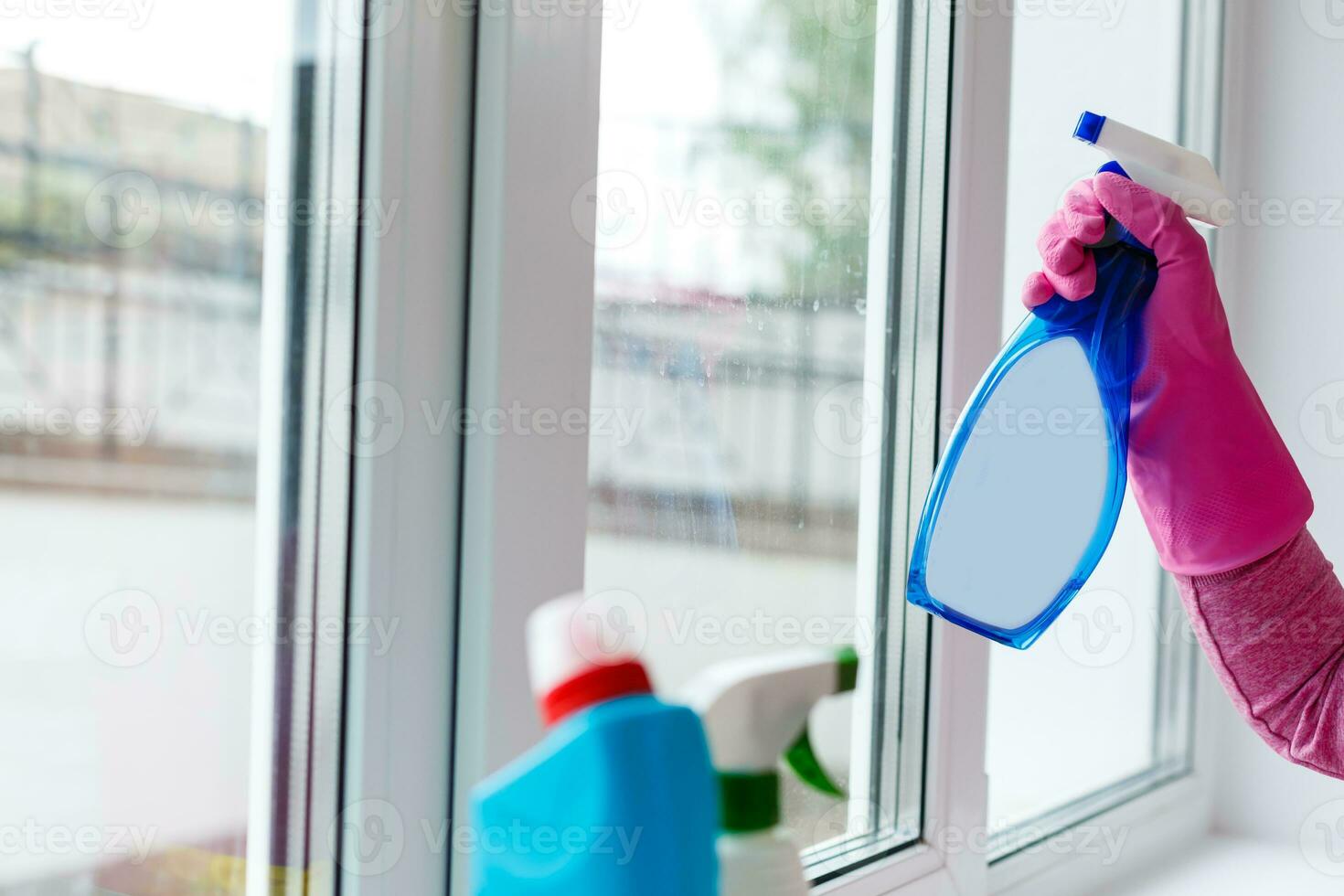 before and after concept - close up of female hand cleaning window with special rag photo