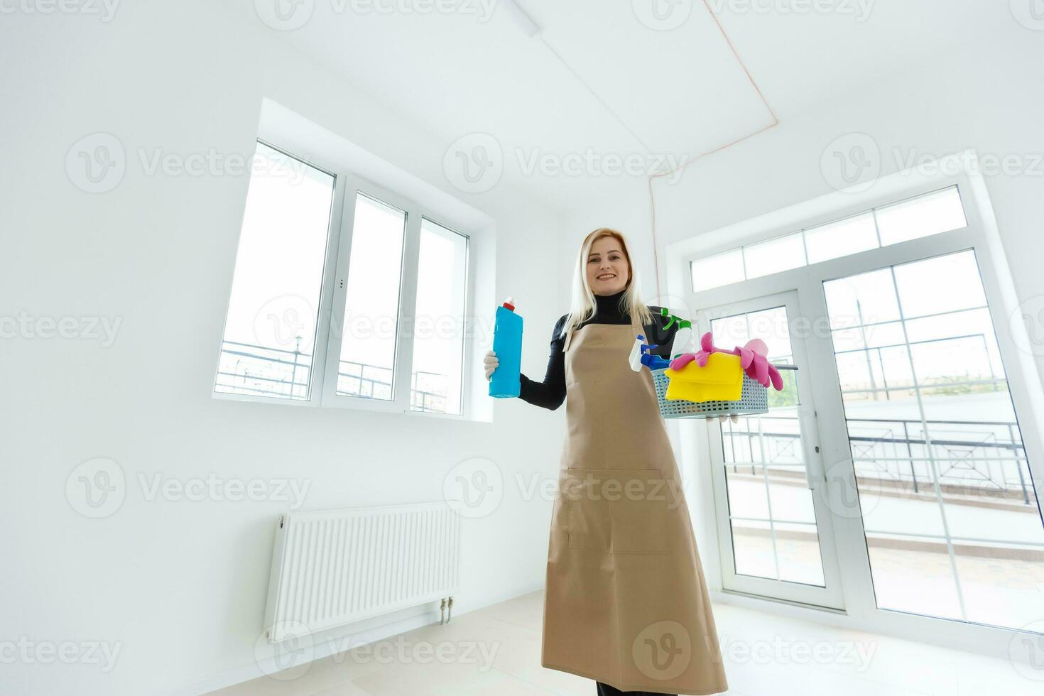Beautiful woman in protective gloves cleaning office photo
