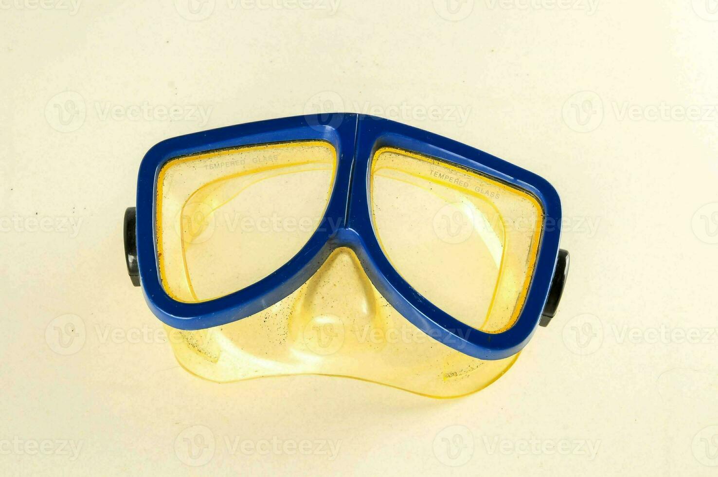 a yellow and blue diving mask with blue goggles photo
