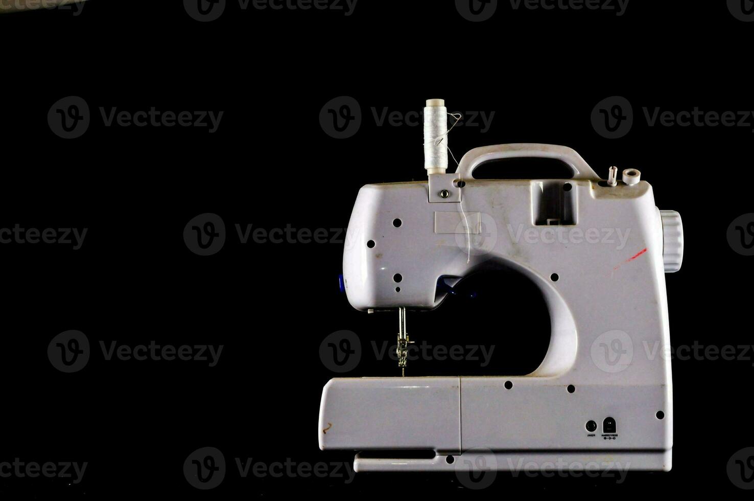 a sewing machine is shown on a black background photo