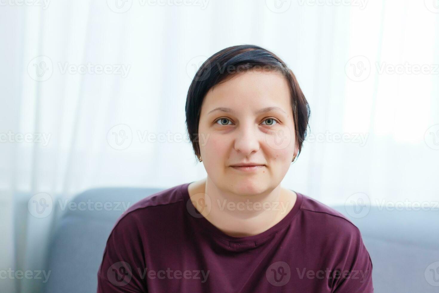 Headshot portrait of smiling young woman. girl with happy facial expression looking at camera with joy, communicating with friends via internet telephony, making video call. Close up. Front view photo