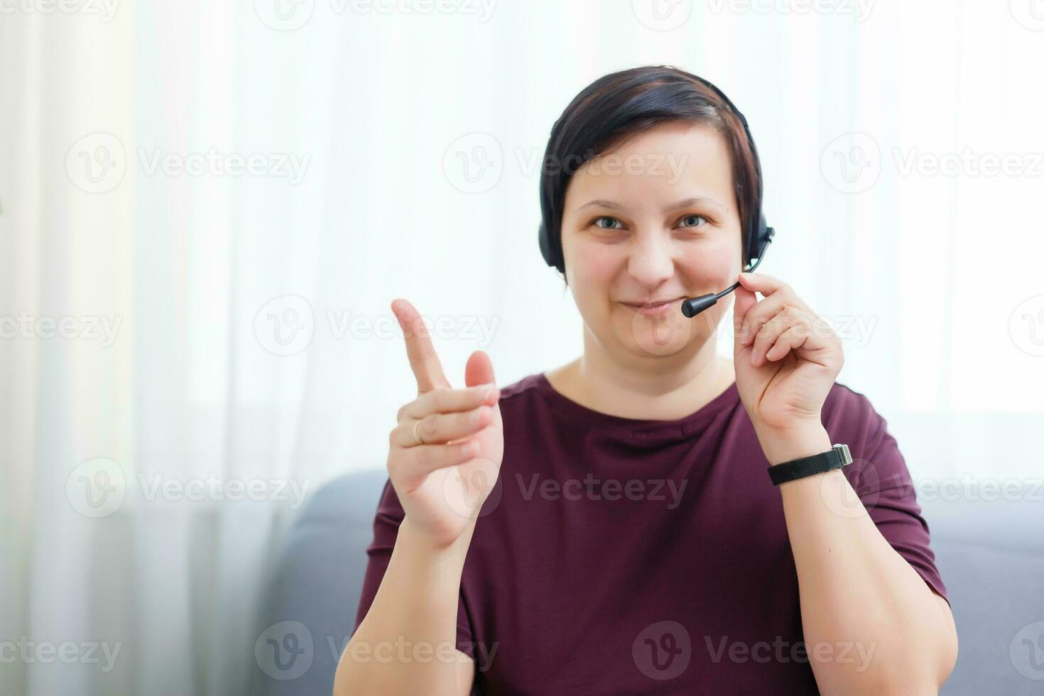 Headshot portrait of smiling young woman. girl with happy facial expression looking at camera with joy, communicating with friends via internet telephony, making video call. Close up. Front view photo