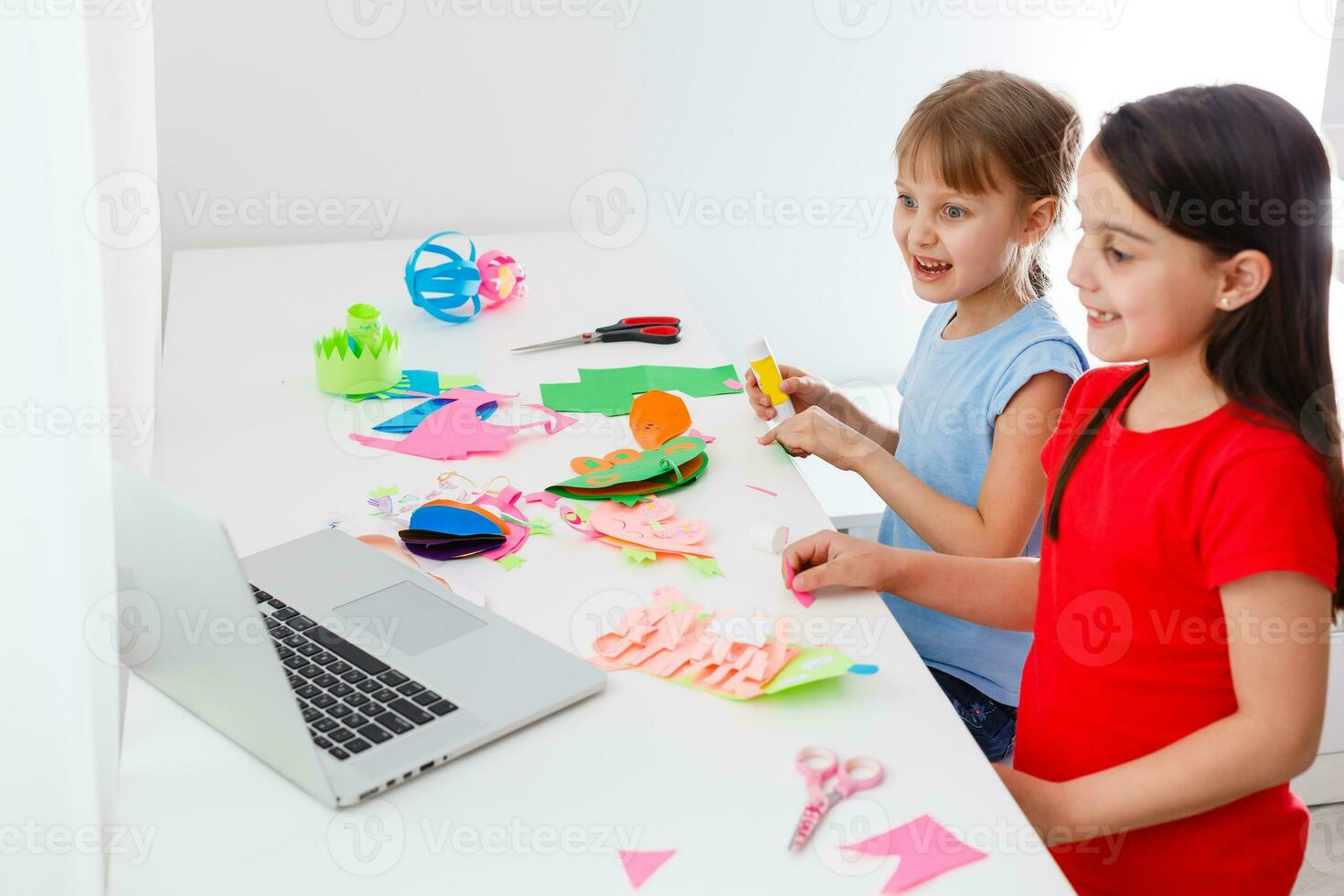 Cool online school. Kids studying online at home using a laptop. Cheerful young little girls using laptop computer studying through online e-learning system. Distance or remote learning photo