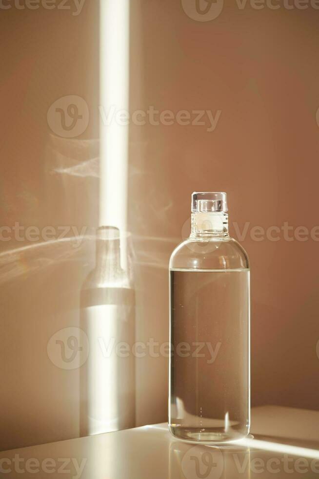 A bottle of clean drinking water in a ray of morning sun. photo