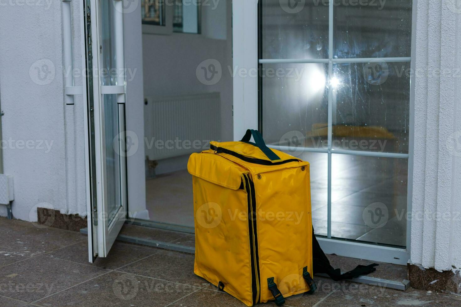 delivery thermo backpack near the entrance to the house photo