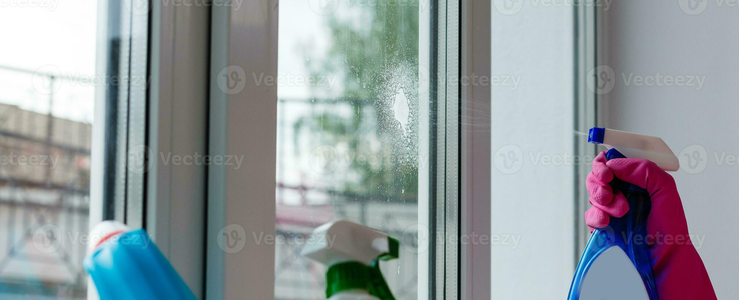 before and after concept - close up of female hand cleaning window with special rag photo