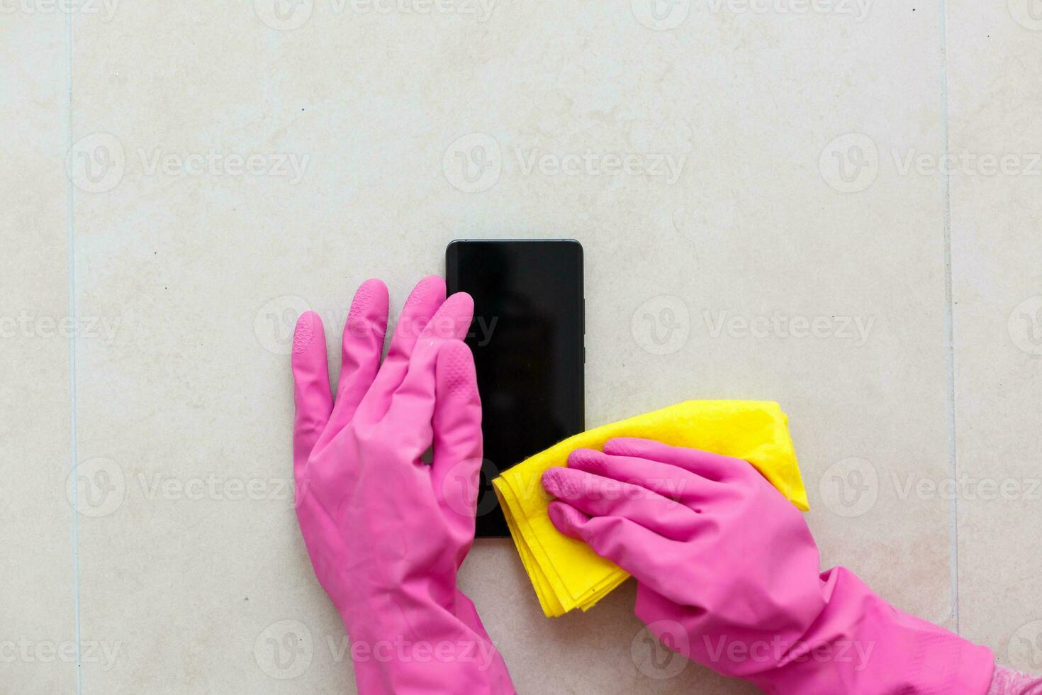 Cleaning the smartphone screen with a fiber cloth from dirt dust and other external factors. Mobile Care Concept photo