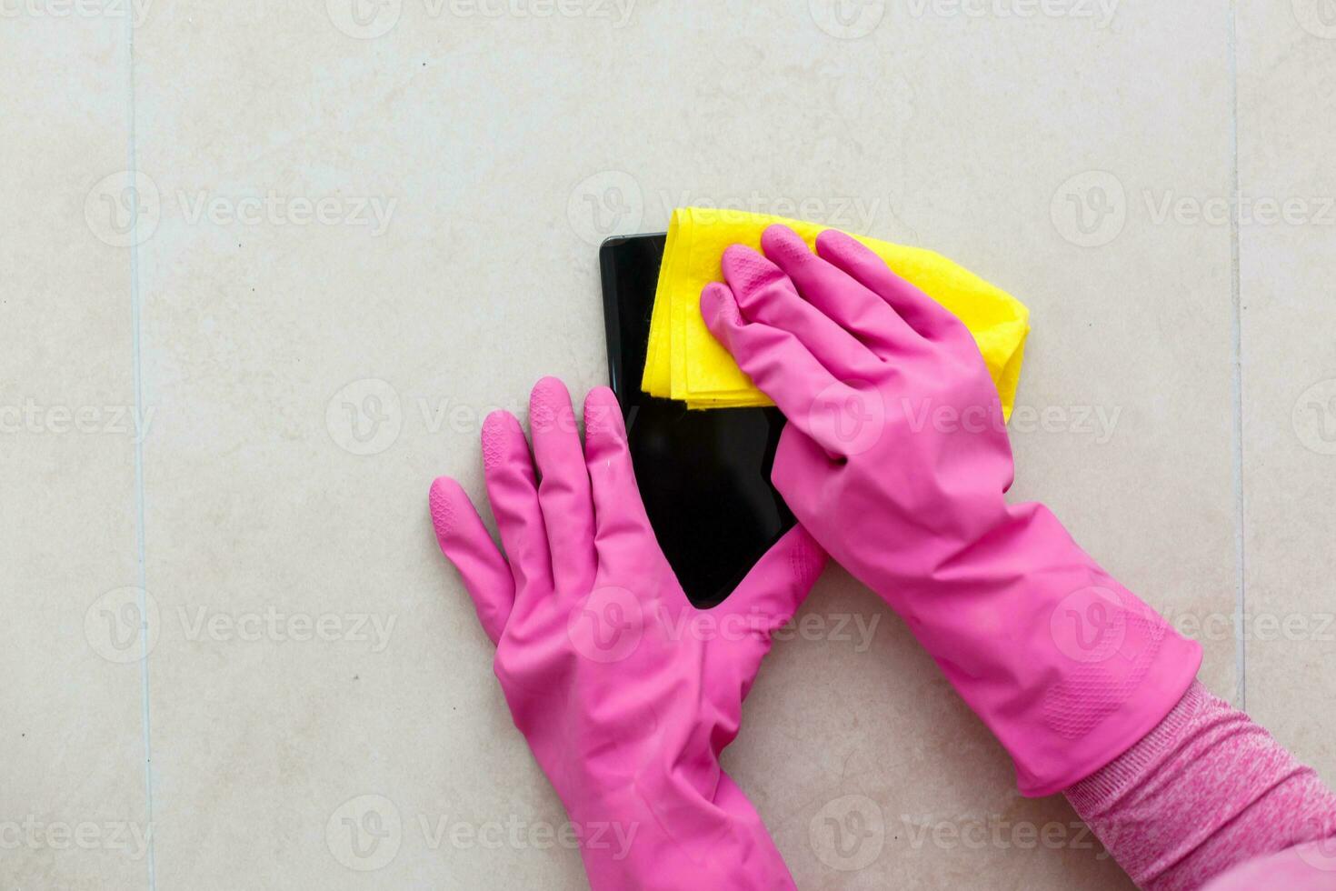 Cleaning the smartphone screen with a fiber cloth from dirt dust and other external factors. Mobile Care Concept photo