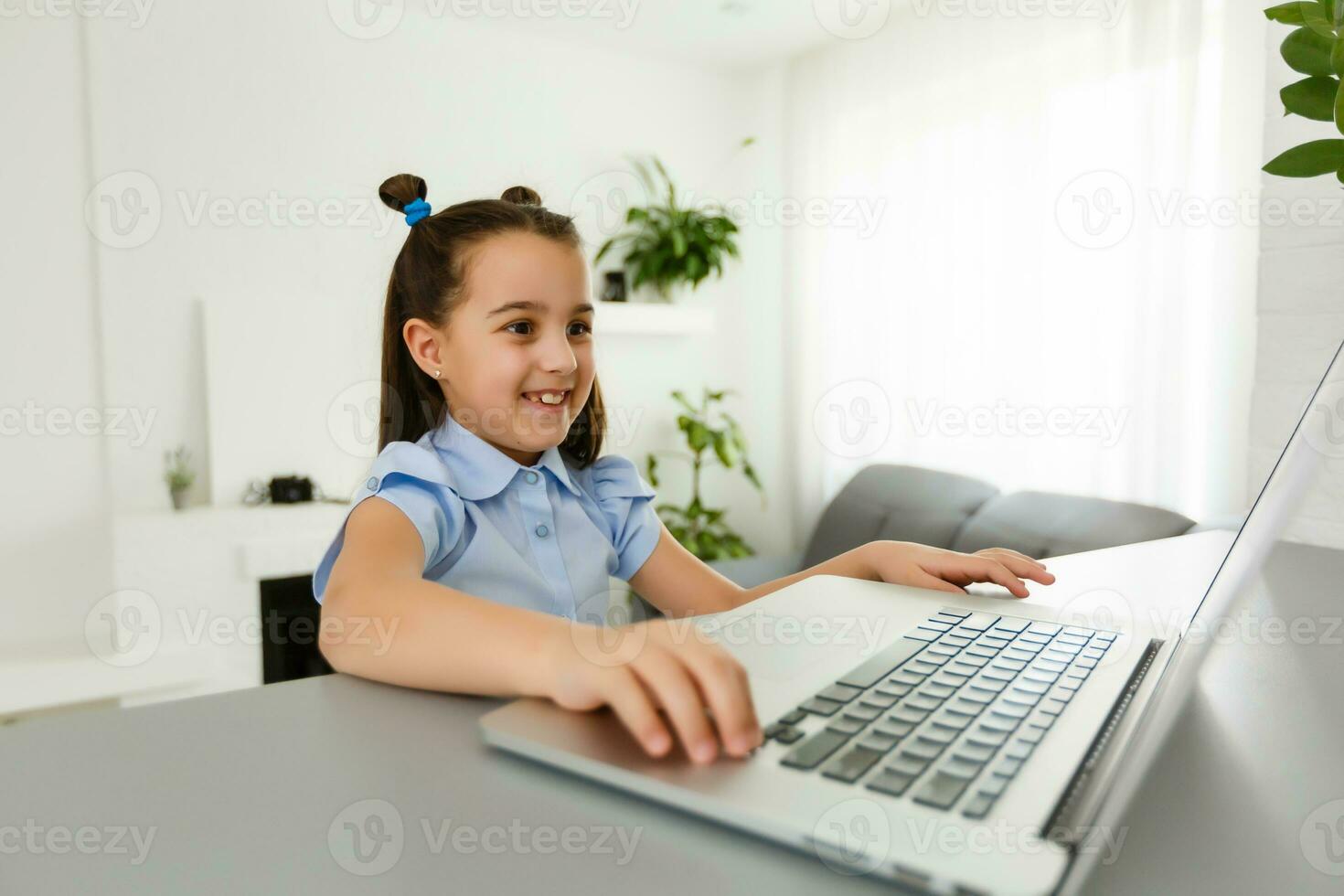 Pretty stylish schoolgirl studying homework math during her online lesson at home, social distance during quarantine, self-isolation, online education concept, home schooler photo