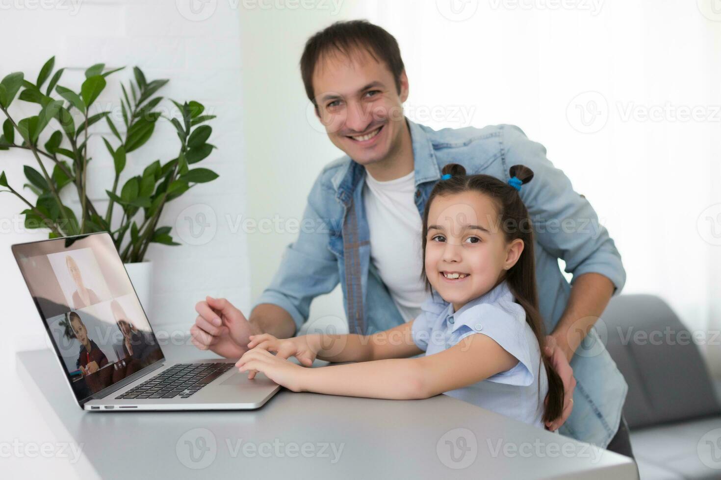 Coronavirus concept. father and daughter learning from home photo