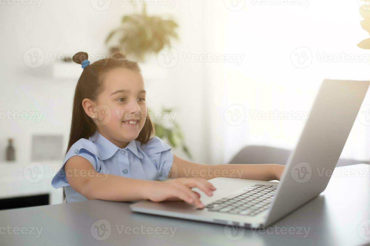 Pretty stylish schoolgirl studying homework math during her online lesson at home, social distance during quarantine, self-isolation, online education concept, home schooler photo