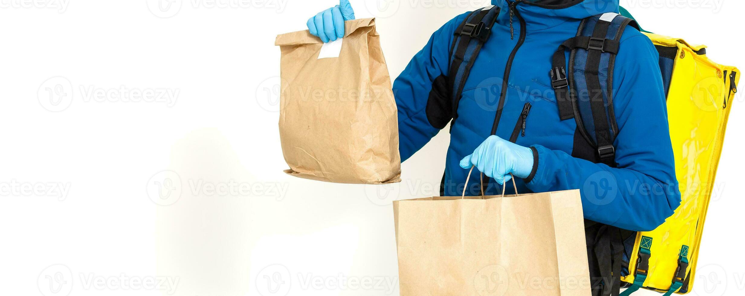 Young courier with thermo bag on white background. Food delivery service photo