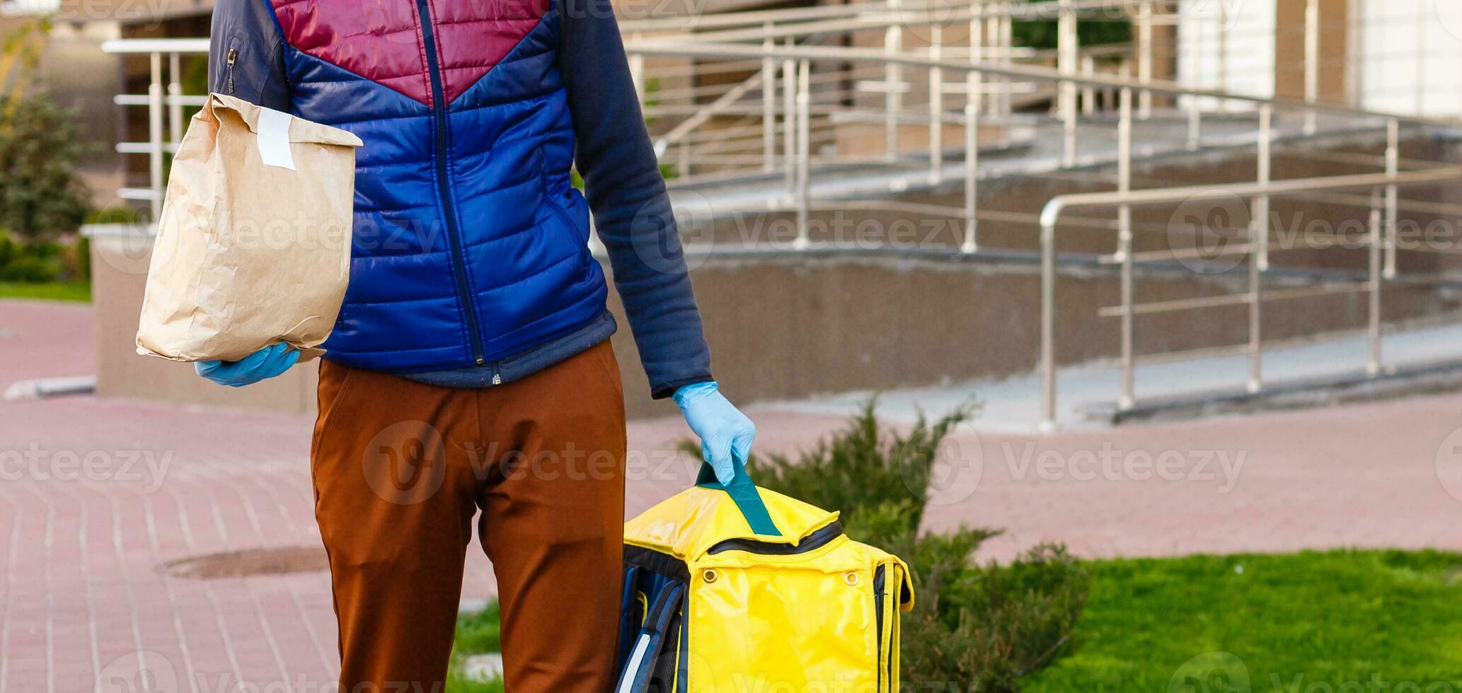 delivery man send food bag at door knob for contactless or contact free from delivery rider in front house for social distancing for infection risk. photo