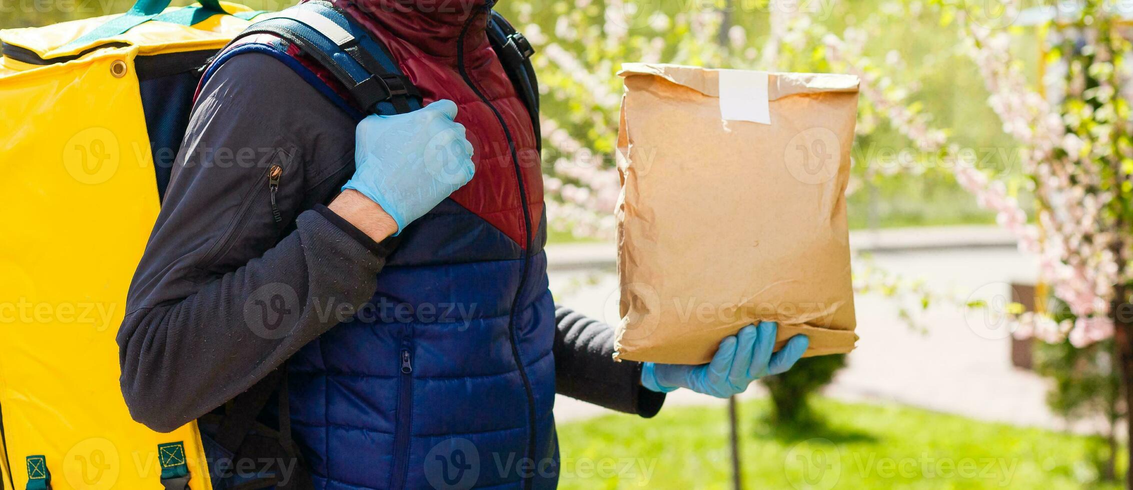 delivery man send food bag at door knob for contactless or contact free from delivery rider in front house for social distancing for infection risk. photo